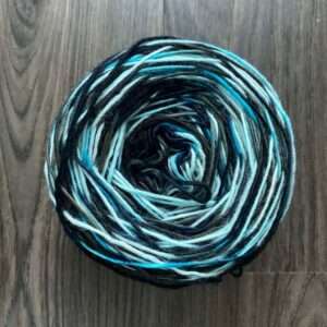 Caked skein of blue and black yarn